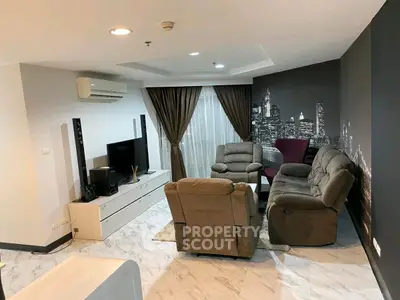 Modern living room with cityscape wallpaper and cozy seating area.