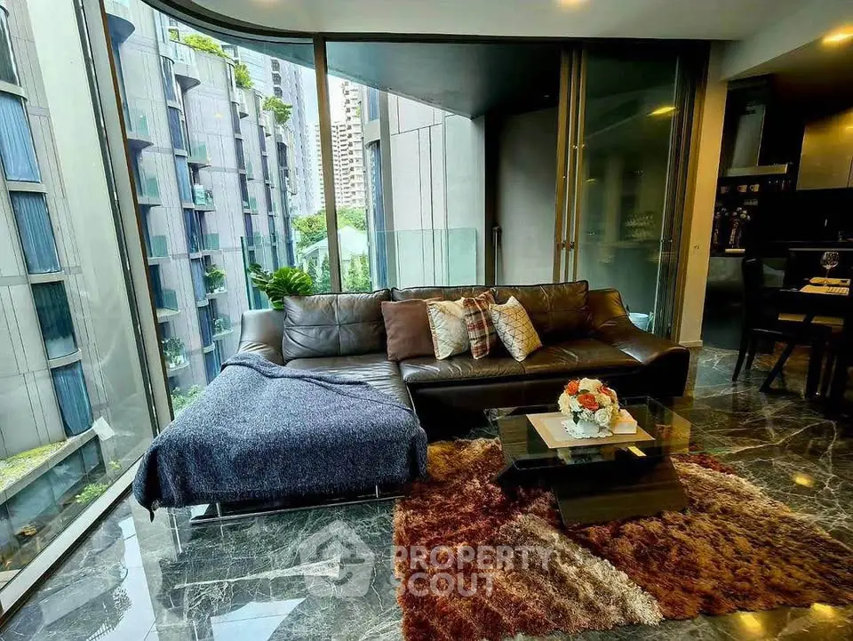 Luxurious living room with floor-to-ceiling windows and modern decor in urban apartment.