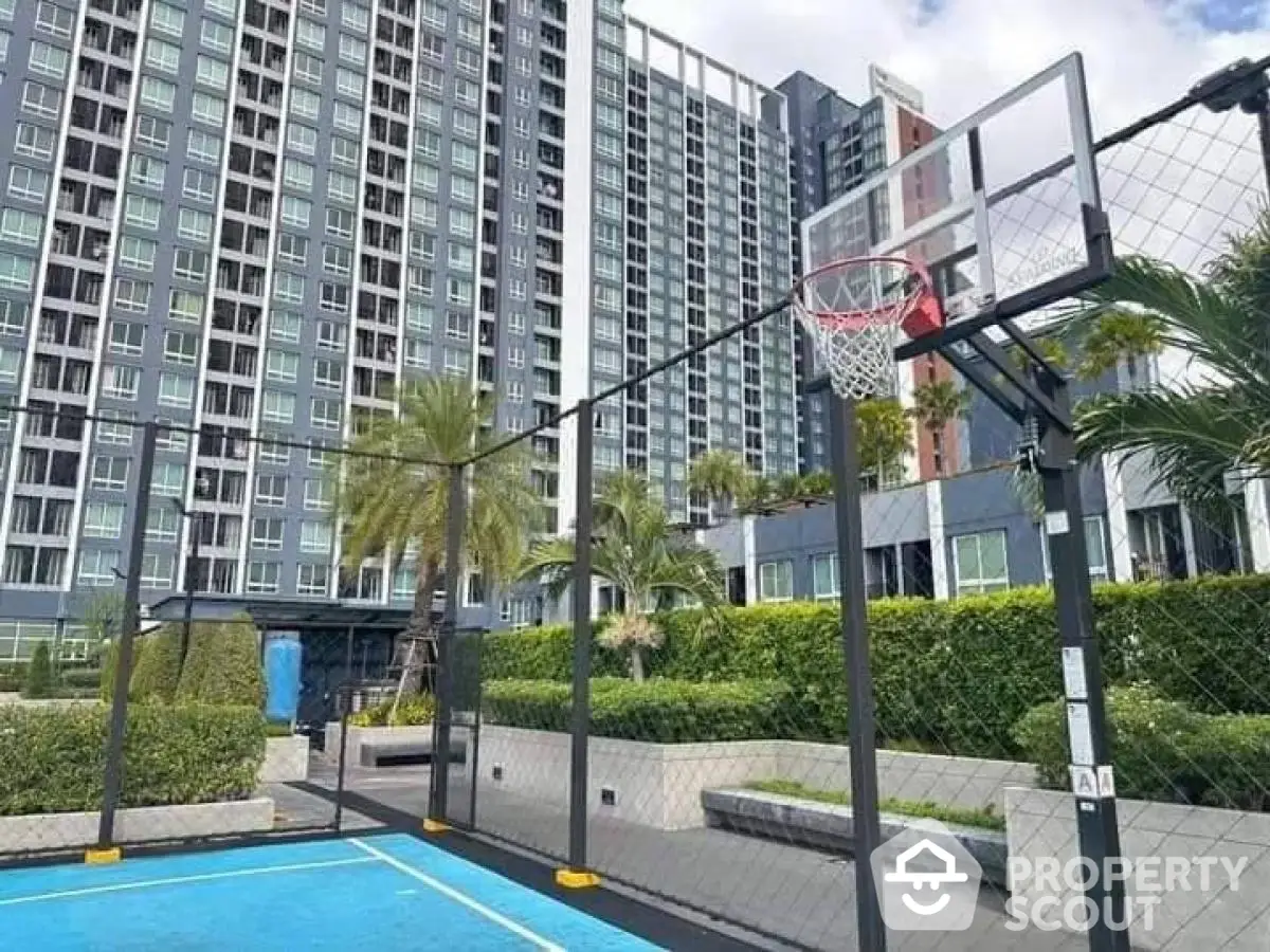 Modern condominium with outdoor basketball court and lush greenery