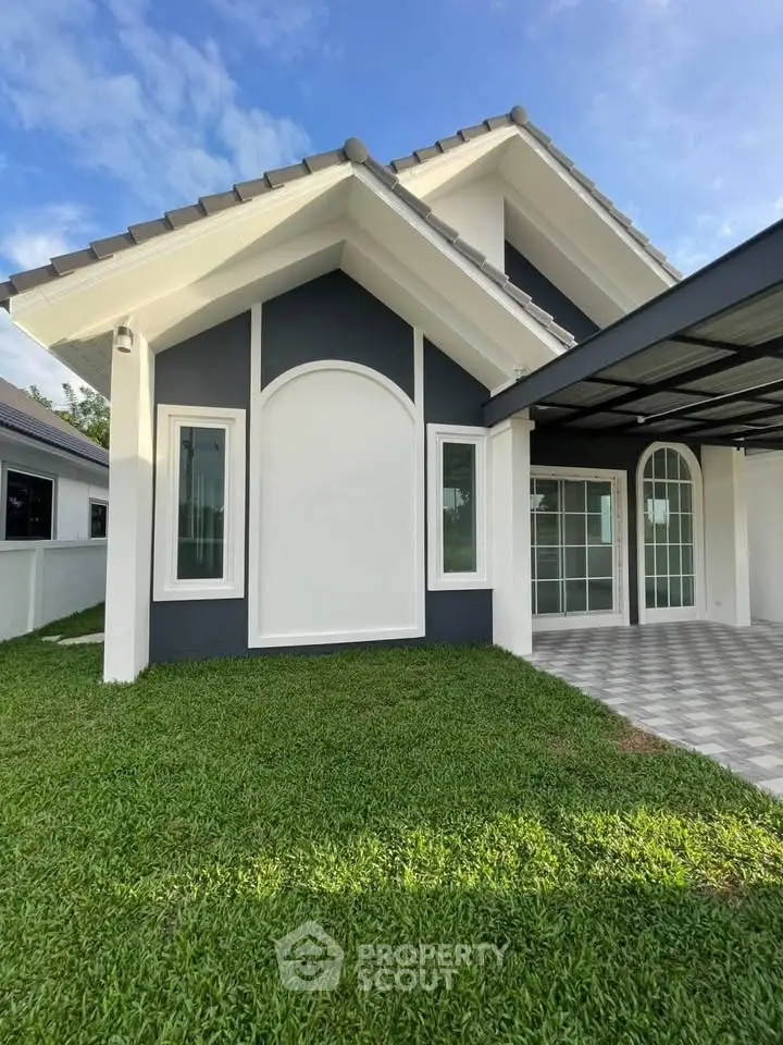 Charming modern house exterior with lush green lawn and stylish architecture.