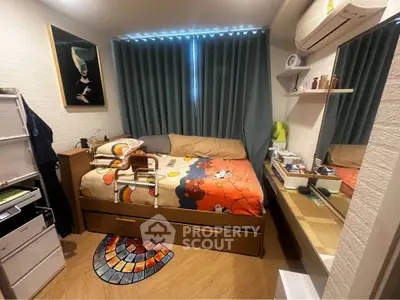 Cozy bedroom with vibrant decor and ample storage, featuring a comfortable bed and modern air conditioning.