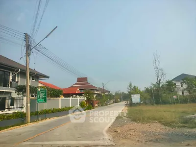 Charming suburban street with modern houses and lush greenery, perfect for family living.