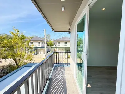 Spacious balcony with modern railing and scenic neighborhood view