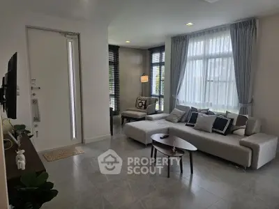 Modern living room with stylish sofa and natural light, perfect for relaxation and entertainment.