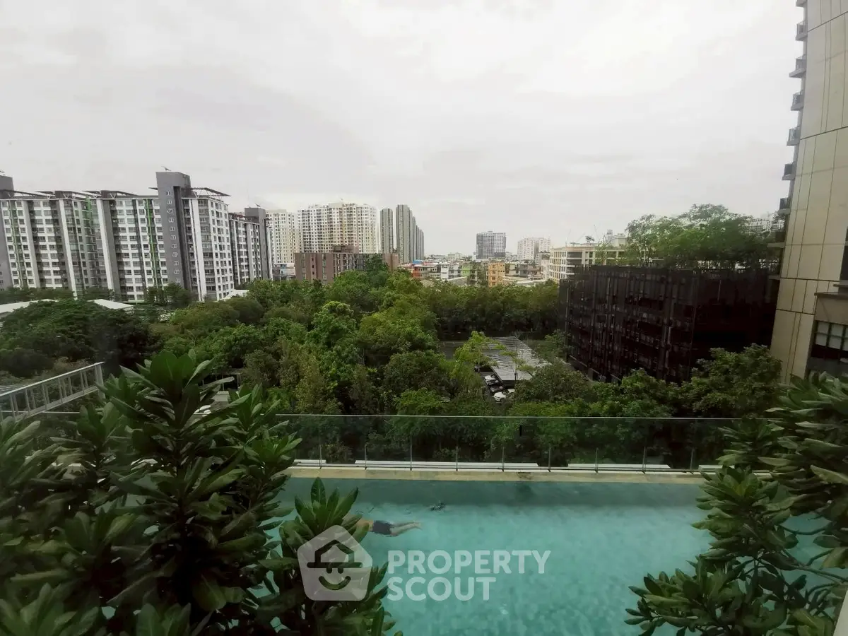 Stunning cityscape view with lush greenery and modern pool