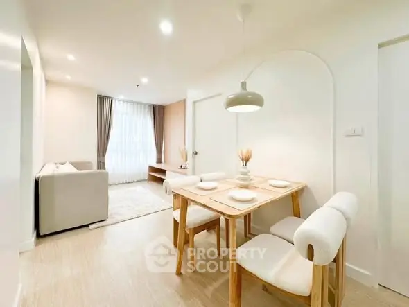Modern dining area with elegant decor and natural light in a stylish apartment.