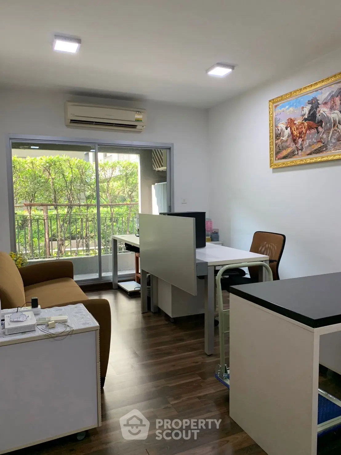 Modern study room with balcony view, featuring sleek furniture and natural light.