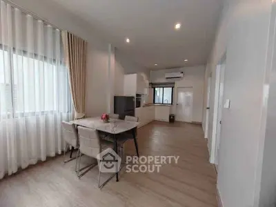 Modern open-layout kitchen and dining area with sleek design and natural light.