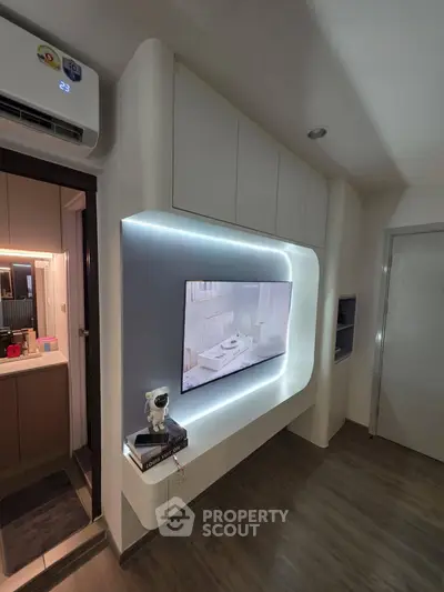 Modern living room with sleek TV setup and ambient lighting