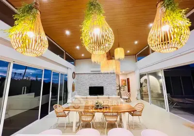 Stunning modern living room with high ceilings, elegant lighting, and expansive windows for natural light.