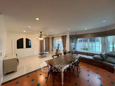Spacious living room with elegant decor and large windows offering natural light