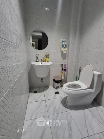 Modern bathroom with sleek white tiles and contemporary fixtures