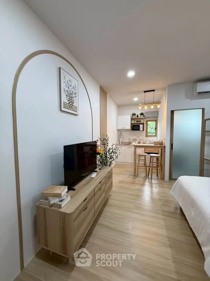 Modern open-plan living room with stylish kitchen and cozy decor