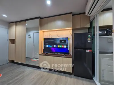 Modern living room with sleek wooden cabinets and smart TV setup.