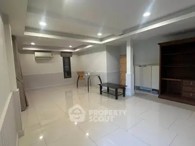 Spacious modern living room with sleek tile flooring and minimalist furniture