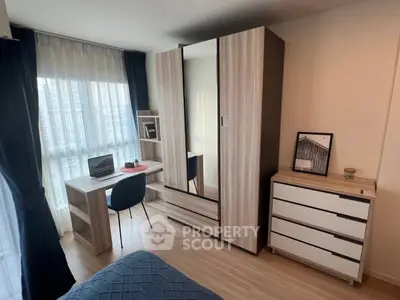 Modern bedroom with stylish furniture and city view, perfect for urban living.