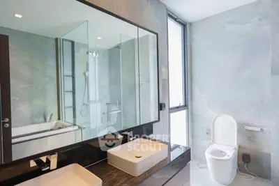 Luxurious modern bathroom with dual sinks and glass shower enclosure