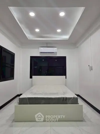 Modern minimalist bedroom with sleek design and ambient lighting