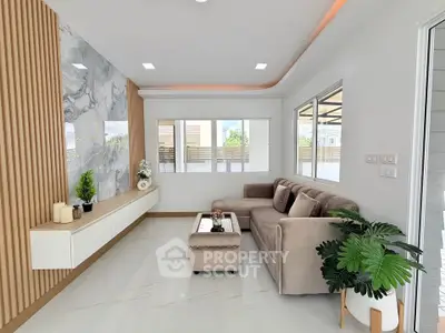 Modern living room with elegant decor and large windows offering natural light.