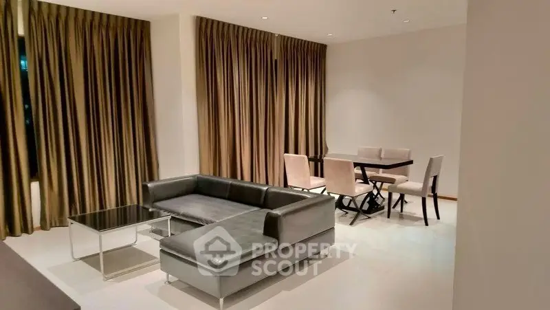 Spacious modern living room with sleek furniture and elegant dining area