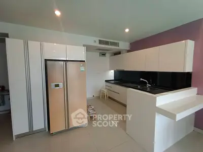 Modern kitchen with sleek cabinets and large refrigerator