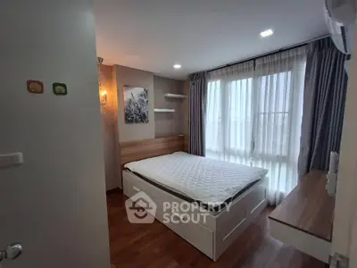 Cozy bedroom with large window and modern decor in a stylish apartment