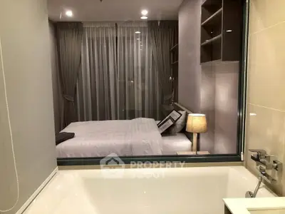 Modern apartment with a view from the bathroom into a cozy bedroom, featuring elegant decor and ambient lighting.