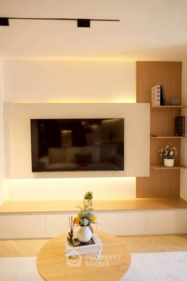 Modern living room with sleek TV setup and stylish shelving, perfect for contemporary living.