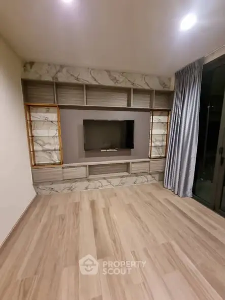 Modern living room with elegant built-in TV unit and marble accents