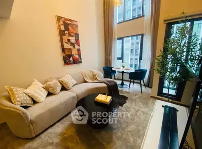 Stylish living room with modern decor and large windows in a high-rise apartment.