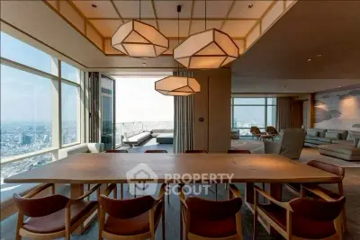 Luxurious penthouse dining area with panoramic city views and modern lighting.