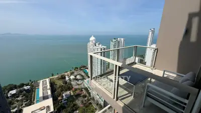 Stunning high-rise balcony with breathtaking ocean view and modern seating area.