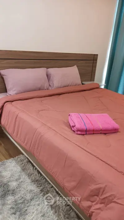 Cozy bedroom with modern wooden headboard and plush bedding.