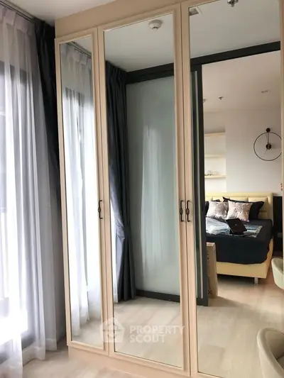 Stylish bedroom with mirrored wardrobe and elegant decor
