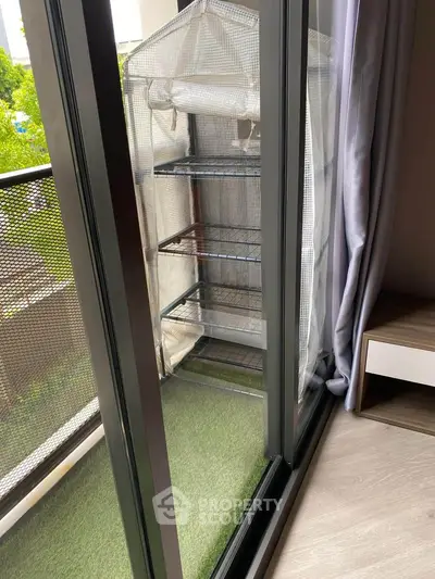 Modern balcony with compact greenhouse and lush greenery view