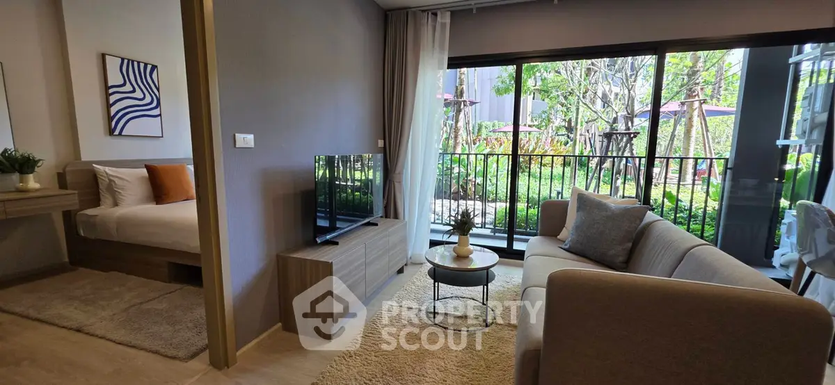 Modern living room with garden view, cozy sofa, and stylish decor in a bright apartment.