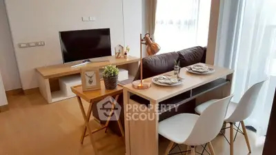 Modern living room with stylish furniture and natural light, perfect for cozy gatherings.