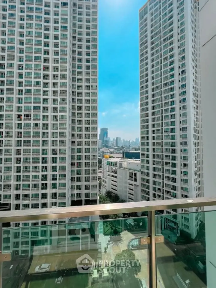 Stunning cityscape view from a high-rise balcony with modern skyscrapers.