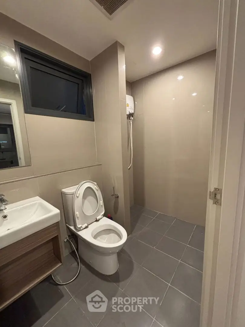 Modern bathroom with sleek design and shower area in contemporary apartment.