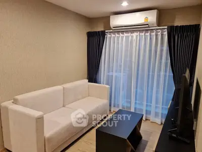 Modern living room with cozy sofa and sleek TV setup, perfect for relaxation and entertainment.