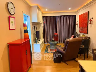 Cozy living room with modern decor, vibrant red accents, and comfortable seating, perfect for relaxation.