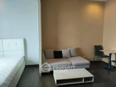 Modern studio apartment with cozy living area and stylish furniture