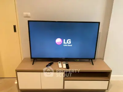 Modern living room with sleek TV setup on stylish wooden console, perfect for entertainment.