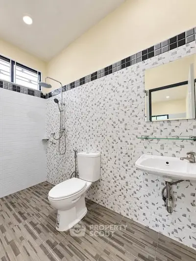 Modern bathroom with stylish tile design and sleek fixtures, perfect for a contemporary home.