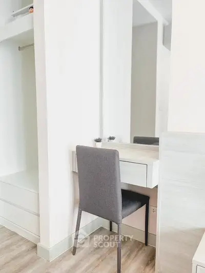 Modern minimalist bedroom with sleek vanity and stylish chair