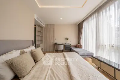 Luxurious bedroom with elegant decor and large windows offering natural light.