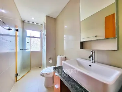 Modern bathroom with sleek fixtures and glass shower enclosure