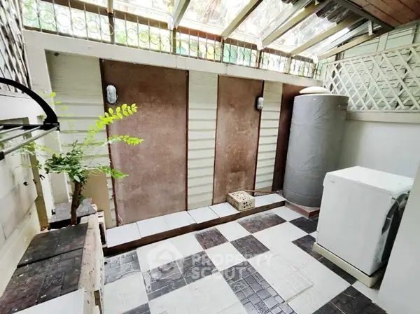 Charming outdoor laundry area with natural light and modern washing machine
