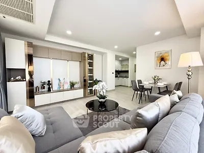 Spacious modern living room with elegant decor and open dining area