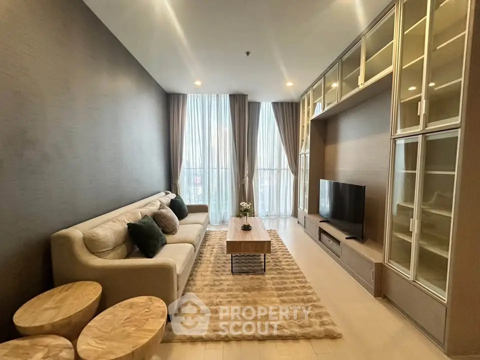 Luxurious living room with elegant decor and large windows for natural light.